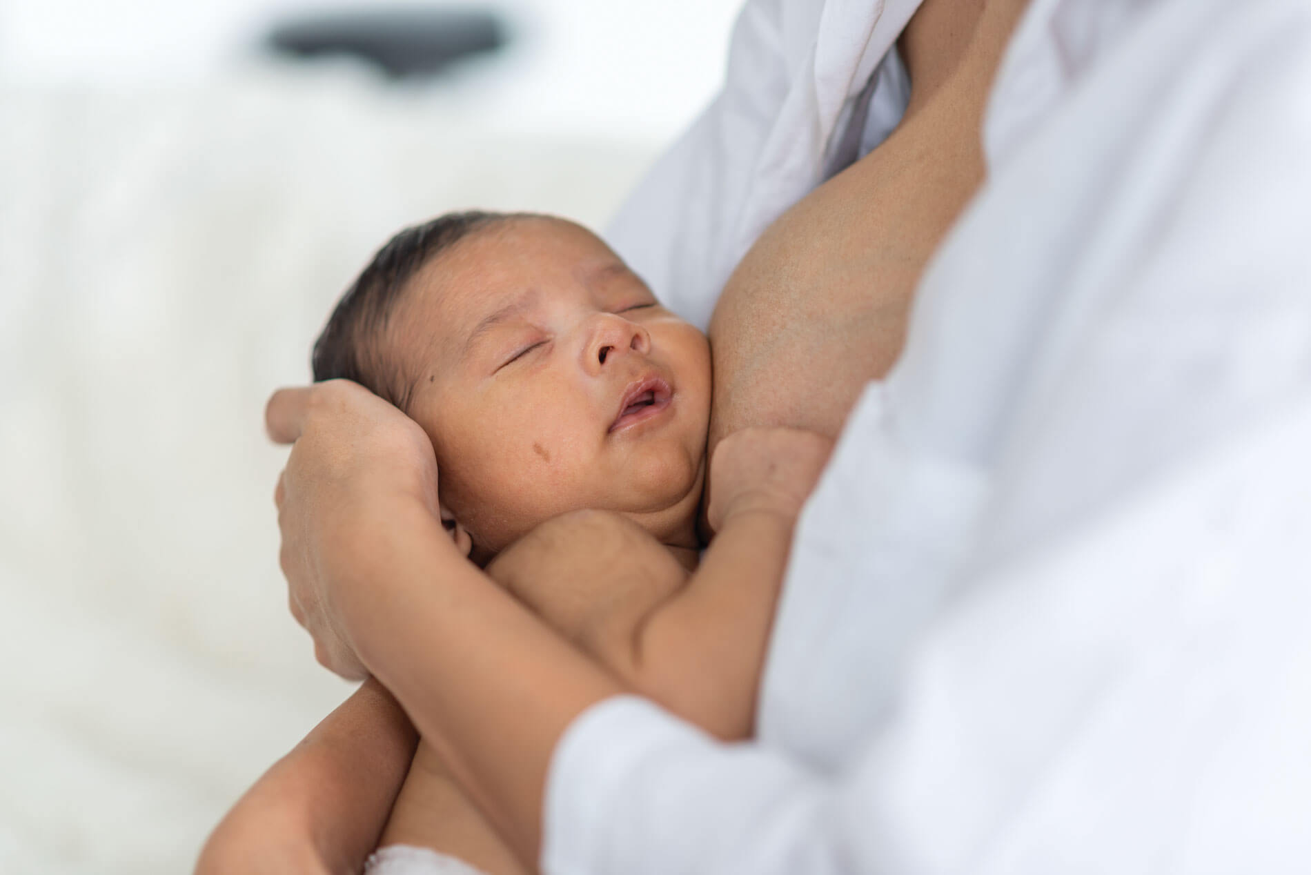 Mother holding her sleeping newborn
