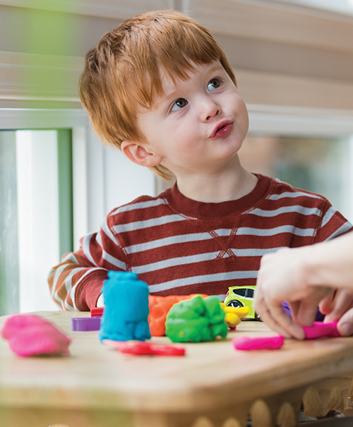 Young boy with red hair playing
